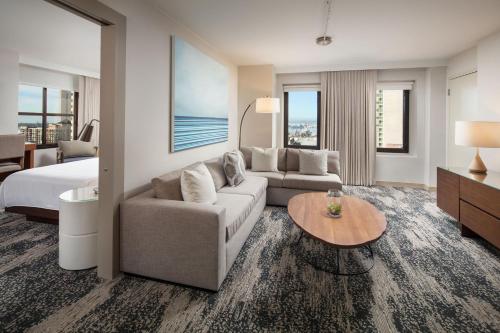 a hotel room with a couch and a bed and a table at The Westin San Diego Gaslamp Quarter in San Diego