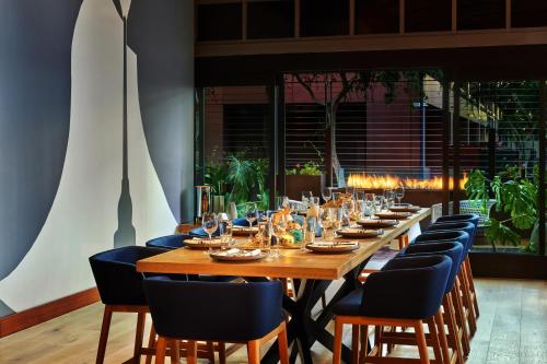a long wooden table with chairs and glasses on it at The Westin San Diego Gaslamp Quarter in San Diego