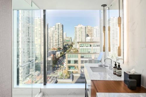 a kitchen with a large window with a view of a city at the DOUGLAS, Autograph Collection in Vancouver