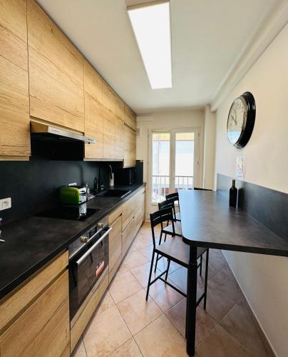 une cuisine avec une table et une salle à manger dans l'établissement The NICE - 3 rooms, 3air cond, 3TV, 3fans, 2 wc, WIfi everywhere 5min aeroport, train, beach, 1min tram, 15 min centre, port, parking possible, à Nice
