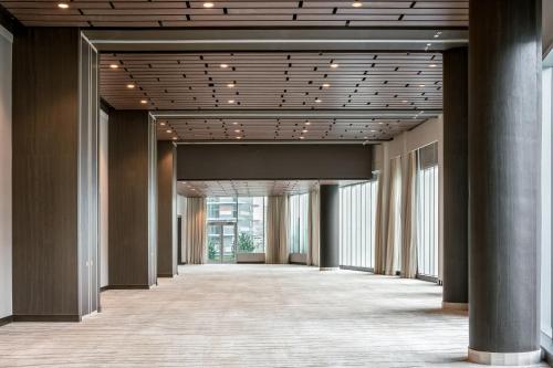 an empty hallway in a building with columns and ceilings at the DOUGLAS, Autograph Collection in Vancouver