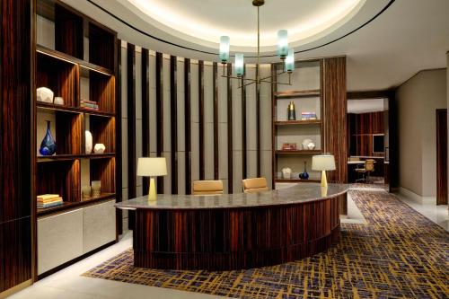 a lobby with a table and chairs in a room at The Westin Surabaya in Surabaya