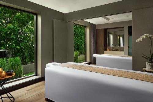 a bathroom with a large tub and a large window at The Westin Surabaya in Surabaya