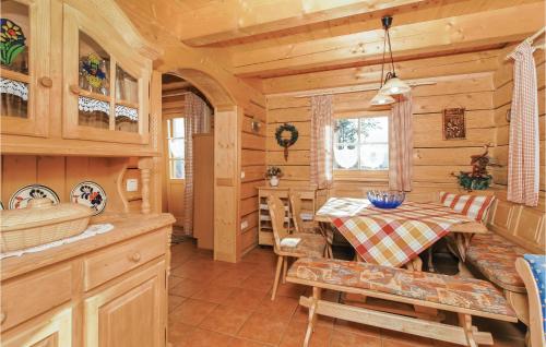 a kitchen and dining room in a log cabin at Lovely Home In Bayerisch Eisenstein With Kitchen in Bayerisch Eisenstein