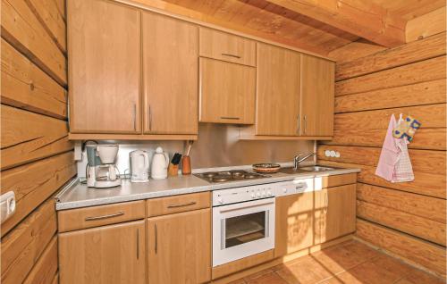 a kitchen with wooden cabinets and a stove at Lovely Home In Bayerisch Eisenstein With Kitchen in Bayerisch Eisenstein
