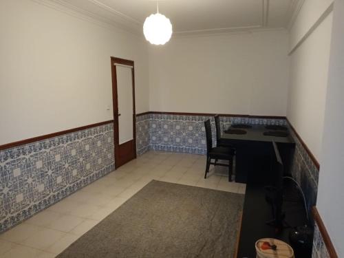 an empty room with a table and chairs in it at GG Massamá Rooms in Queluz