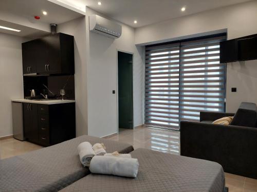 a living room with a bed and a kitchen at Luana Monte Apartments in Amoudara Herakliou