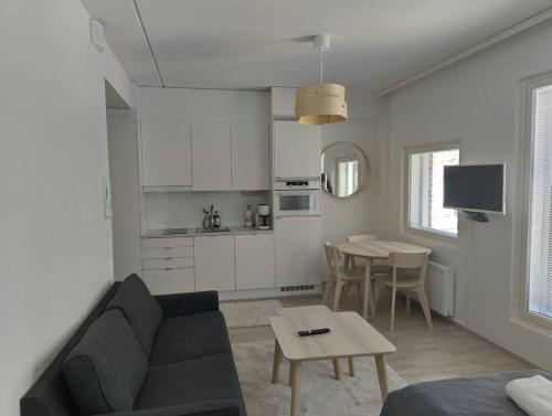 a living room with a couch and a table at New apparment, near of Airport, in Tikkurila in Vantaa