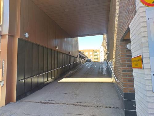 an empty hallway of a building with a tunnel at New apparment, near of Airport, in Tikkurila in Vantaa