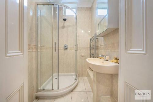 a bathroom with a shower and a sink at The Cromwell Residences in London