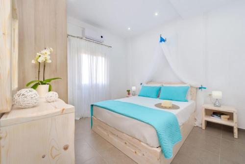 a bedroom with a bed with blue and white at Luxury Vacation Villa Irene with private juccuzi in Fira
