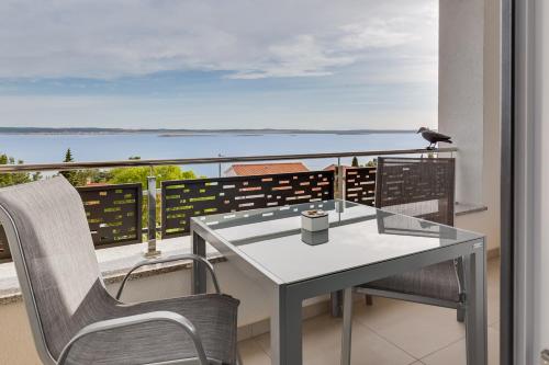 a bird sitting on a table on a balcony at Villa Stjepanovic in Tribanj-Krušćica