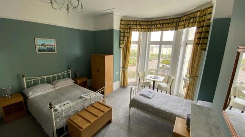 a bedroom with a bed and a window at The Portland Hotel in Folkestone