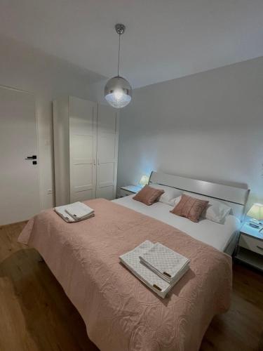 a bedroom with a large bed with two towels on it at Apartment Seaside Orebić in Orebić
