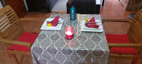 a table with a candle and plates of food on it at Le Chaleureux in La Gaulette