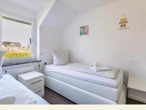 Ένα ή περισσότερα κρεβάτια σε δωμάτιο στο Meertraum Premium Wohnung mit 3 Zimmern, 250m zum Strand