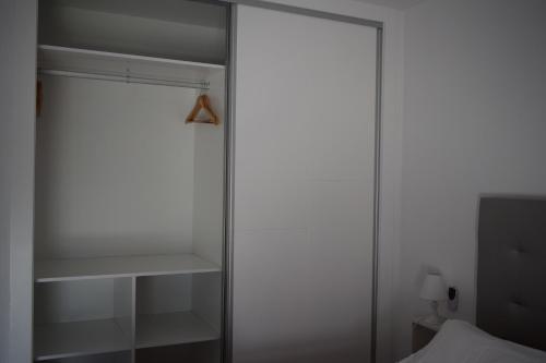 a closet with a glass door and a shelf at barbara 20 playa muchavista alicante in El Campello