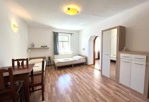 a living room with a table and a dining room at Apartmány Na Rynku Chvalšiny 18 in Český Krumlov