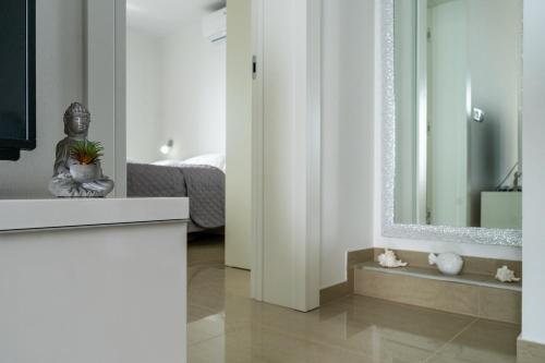 a white room with a mirror and a bed at Villa Stjepanovic in Tribanj-Krušćica