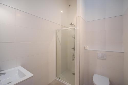 a bathroom with a shower and a toilet and a sink at Domaine d'Essendiéras in Saint-Médard-dʼExcideuil