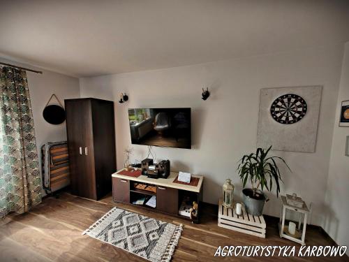 a living room with a tv on the wall at Agroturystyka Karbowo in Brodnica
