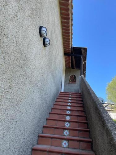 a stairway with a pair of glasses on a wall at Appartamenti Su Pasiu in Chia