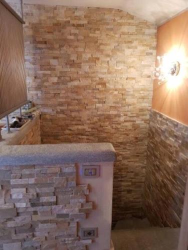 a bathroom with a stone wall and a counter at Valtournenche EVETTE in Valtournenche