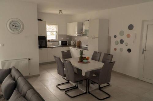 a kitchen and dining room with a table and chairs at Apartman Stella in Pula