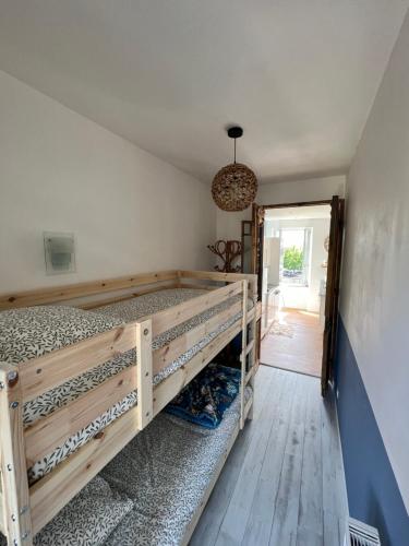 a bedroom with a bunk bed and a hallway at Détente et vue exceptionnelle à L'appart' de Charles in Dole