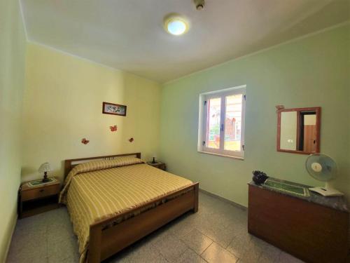 a bedroom with a bed and a window at Villa Selene "Jole" in Ioppolo