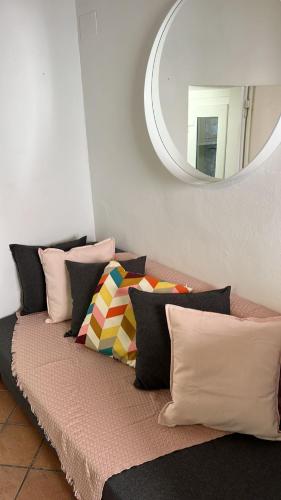 a couch with pillows on it with a mirror at San Giorgino Home in Florence