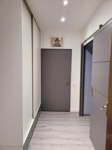 a hallway with a man standing on top of a door at Les Embruns - Plein ciel - appartement 3eme étage in Deauville