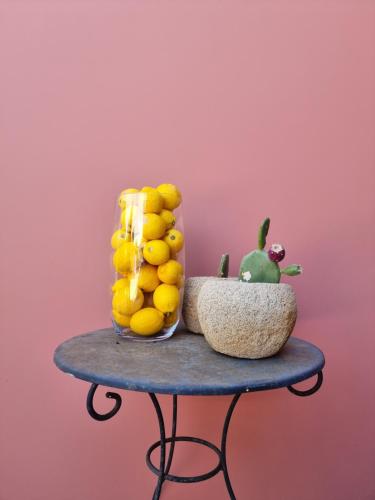 a table with a bowl of lemons and a green plant at Julietta Suites in Argostoli