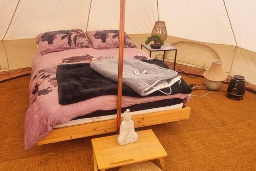 a bedroom with a bed in a tent at Japanese tent Secret garden glamping in Newark-on-Trent