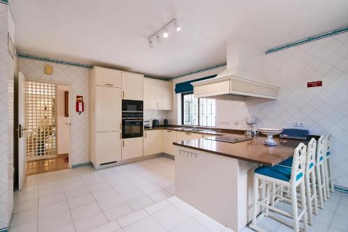 a kitchen with white cabinets and a counter top at Casa Shambala in Carvoeiro