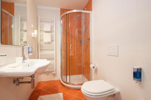 a bathroom with a shower and a toilet and a sink at Echotel in Porto Recanati