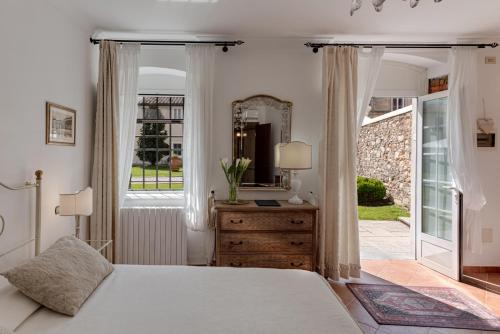 a bedroom with a bed and a dresser and a window at Villa Del Papa in Lucca
