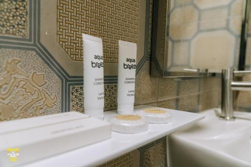 a bathroom with two tubes ofodorizers on a counter at El Palacio Hotel & Resort in Cavite