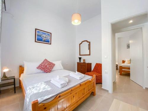 a bedroom with a bed with two towels on it at Aquaterra Askeli Poros in Poros