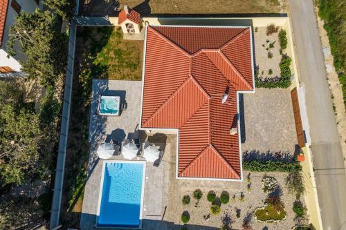an overhead view of a house with a swimming pool at Villa Mattina, with heated pool and jacuzzi in Privlaka