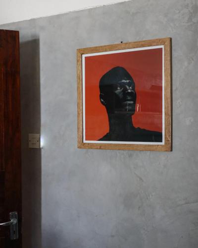 a painting of a black man on a wall at Dar Mar Hostel & Coworking in Paje