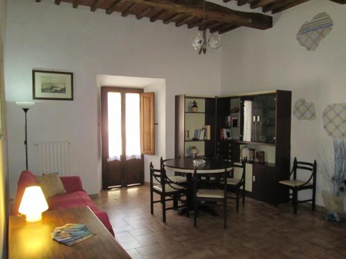a living room with a couch and a table and chairs at Casa Vacanze Sasso Pisano in Sasso Pisano
