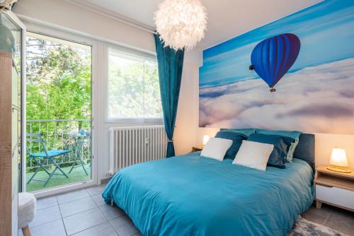 a bedroom with a blue bed and a large window at In the Sky - Casa Vostra - Ambilly proche tramway - frontière in Ambilly