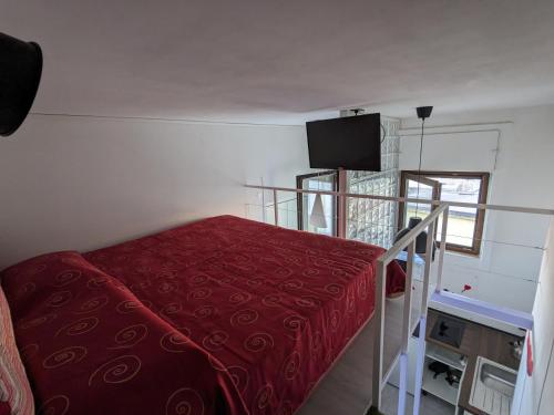 - une chambre avec un lit et une couverture rouge dans l'établissement Napoli City Panorama, à Naples