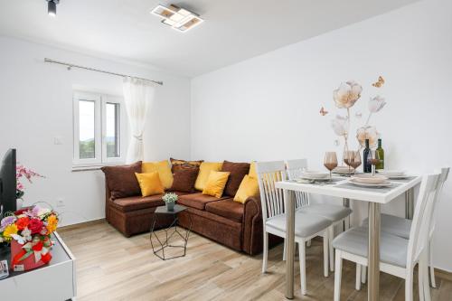 a living room with a couch and a table at Apartment Ivana in Malinska