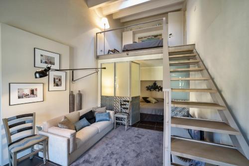 a living room with a couch and a loft bed at Appartamenti con vista - Pomelia in Scicli