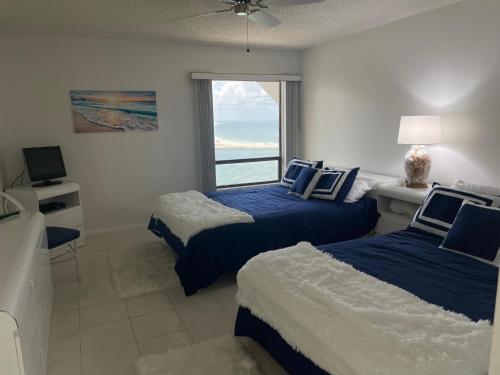 クリアウォーター・ビーチにある440 West Condo 1602N Sensational Gulf-viewのベッド2台と窓のある寝室