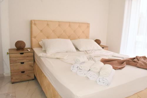 a bedroom with a bed with towels on it at Apartments Amar in Ulcinj