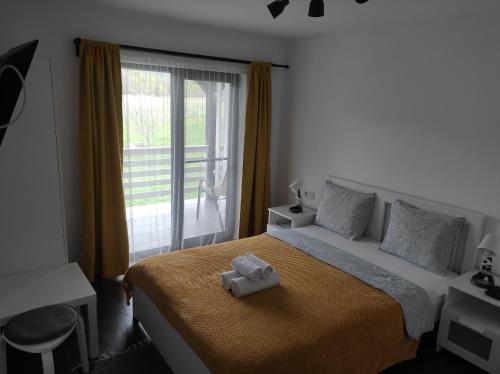 Un dormitorio con una cama con una toalla. en Pensiunea Freya, en Colibiţa