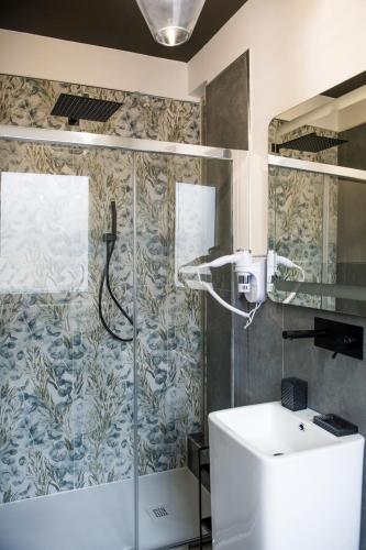 a bathroom with a shower and a sink at Boutique Hotel Ferrara in Ferrara
